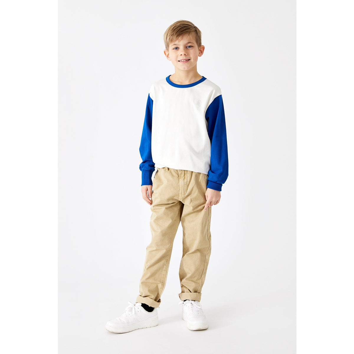 Das Langarmshirt hat einen Aufdruck mit Smileys auf der Rückseite, die Ärmel sind in einem schönen blau gehalten. Der leichte Pullover hat Bündchen an den Ärmeln. Ein cooler Basicartikel für den Winter.